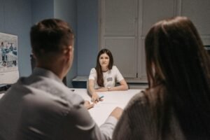 Professional meeting in a healthcare office setting with medical staff discussion.